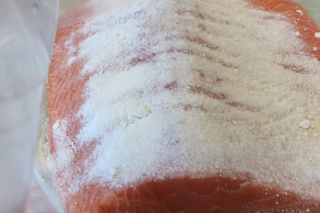 Salting salmon prior to smoking.